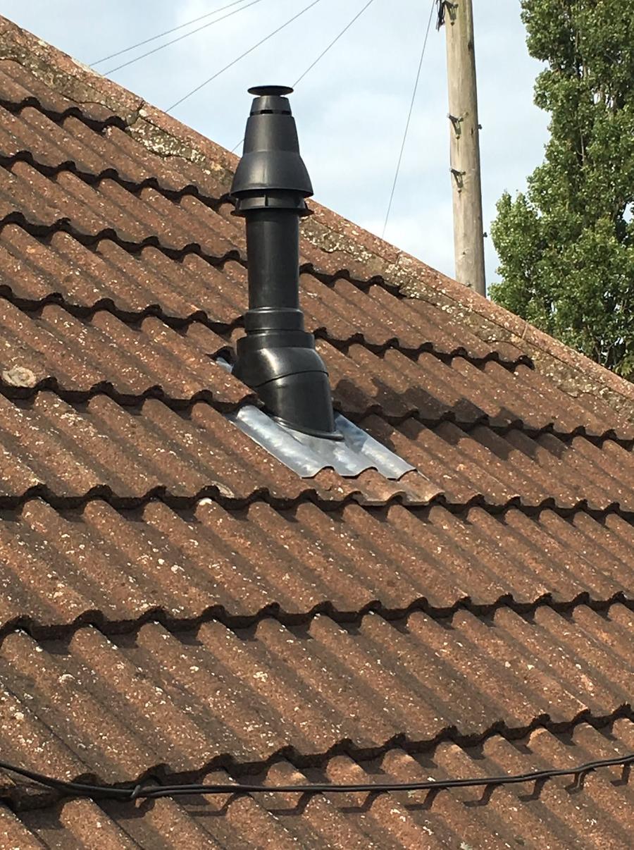 Vertical boiler flue through a tiled roof, fitted by toastd.
