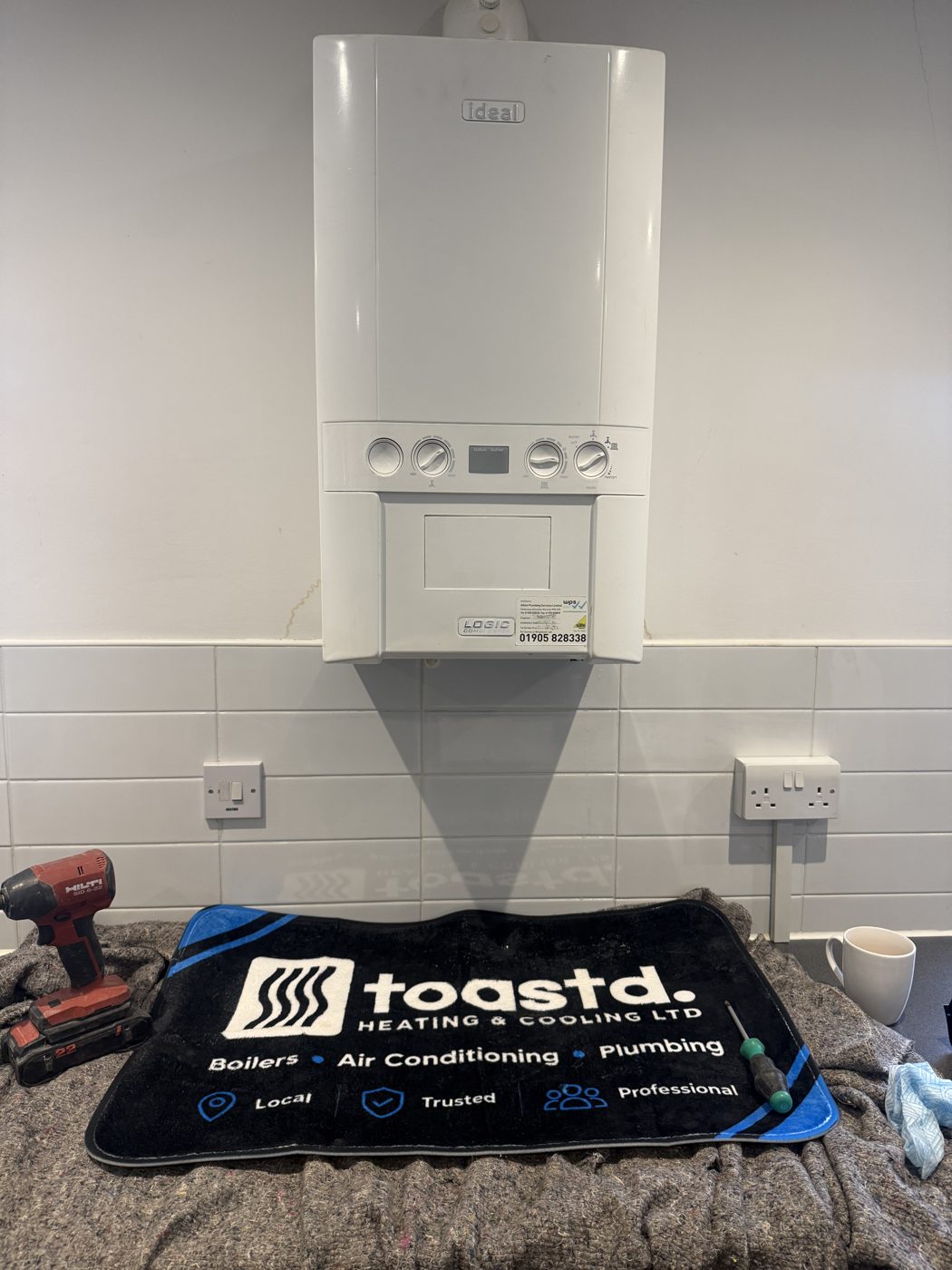 Old Ideal Logic combi boiler on a kitchen wall before replacement